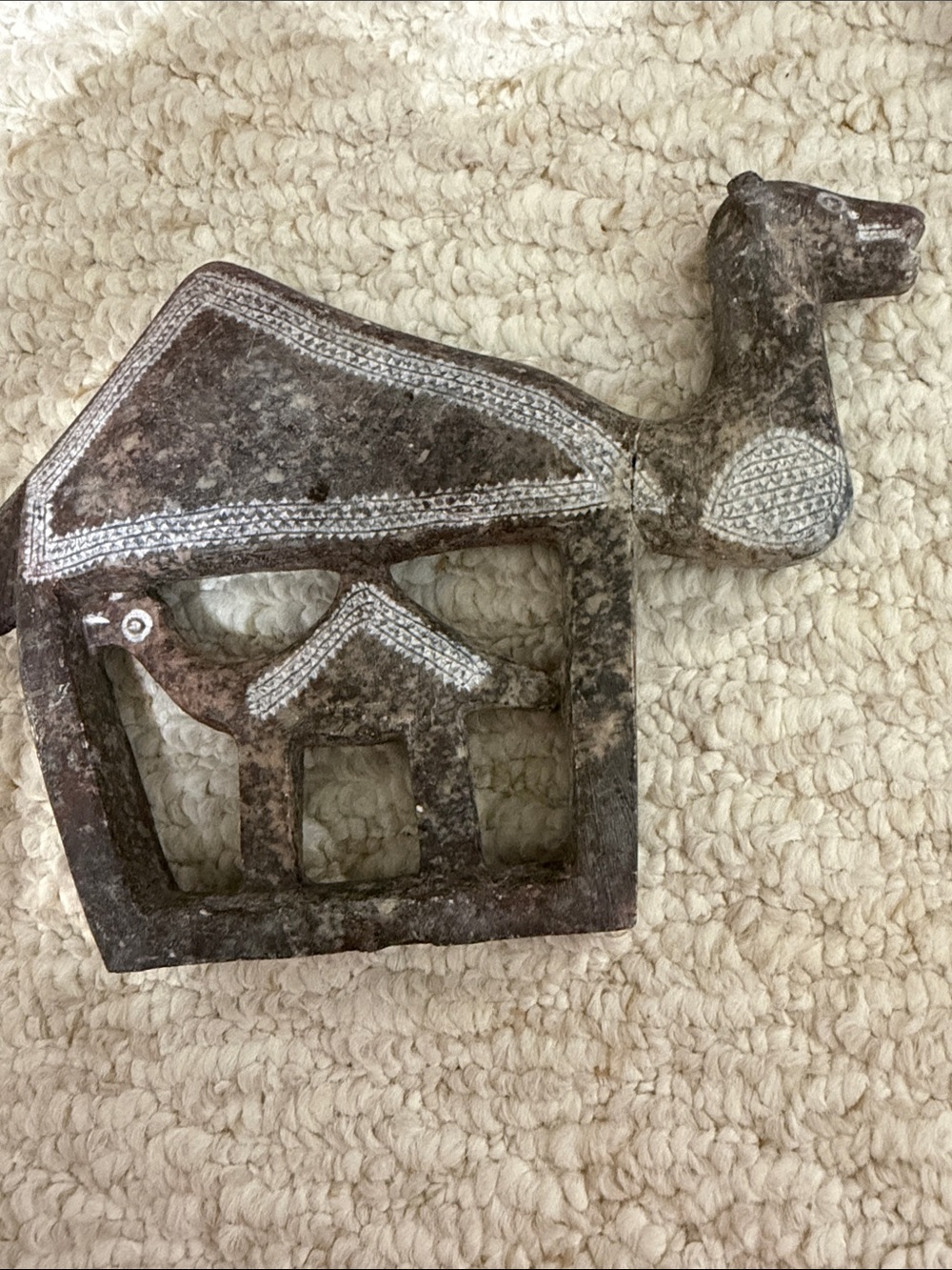 Vintage hand carved soapstone camel featuring a cut out calf neck has a crack